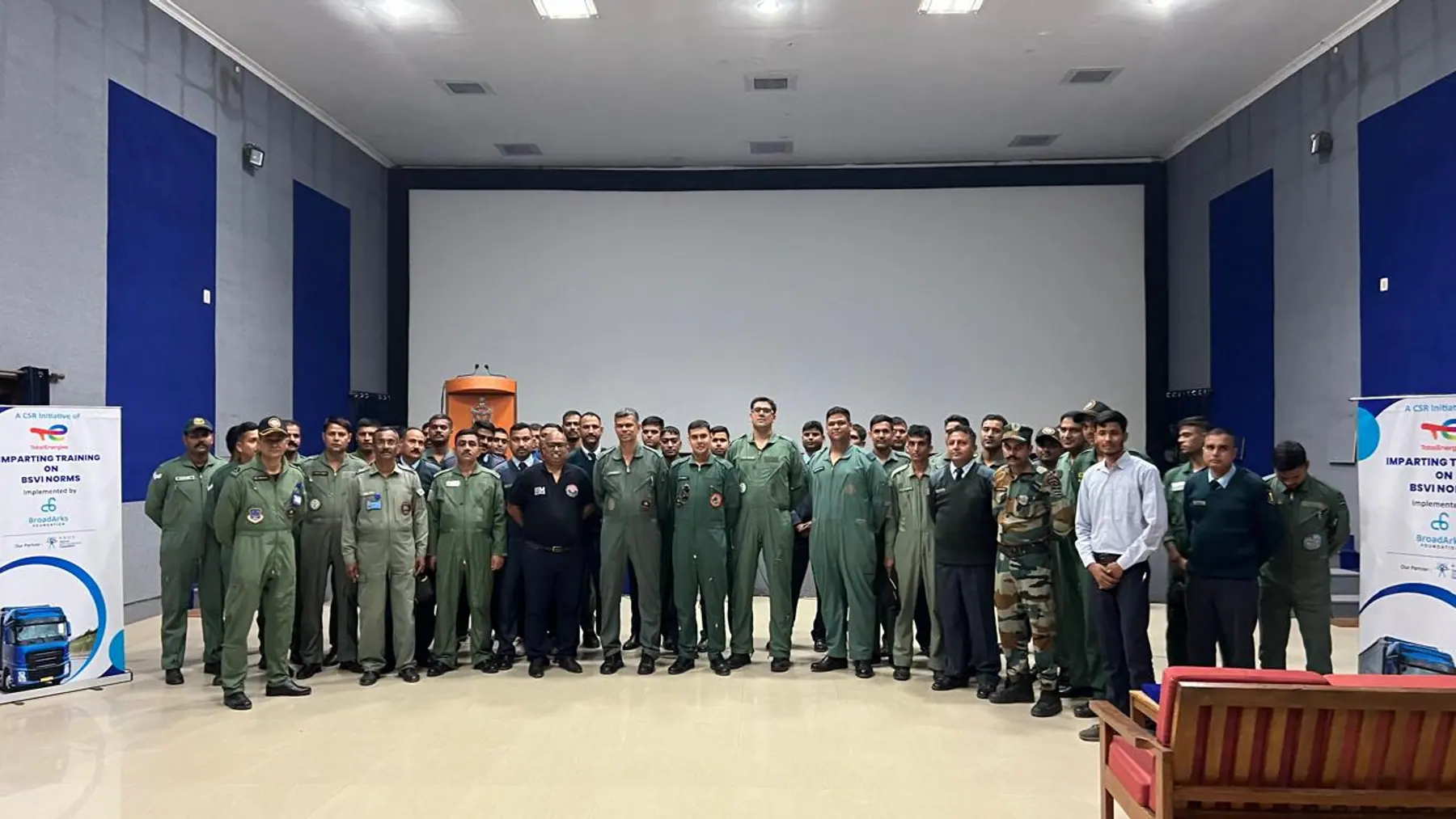 Uniformed personnel assembled in a hall for a technical training briefing