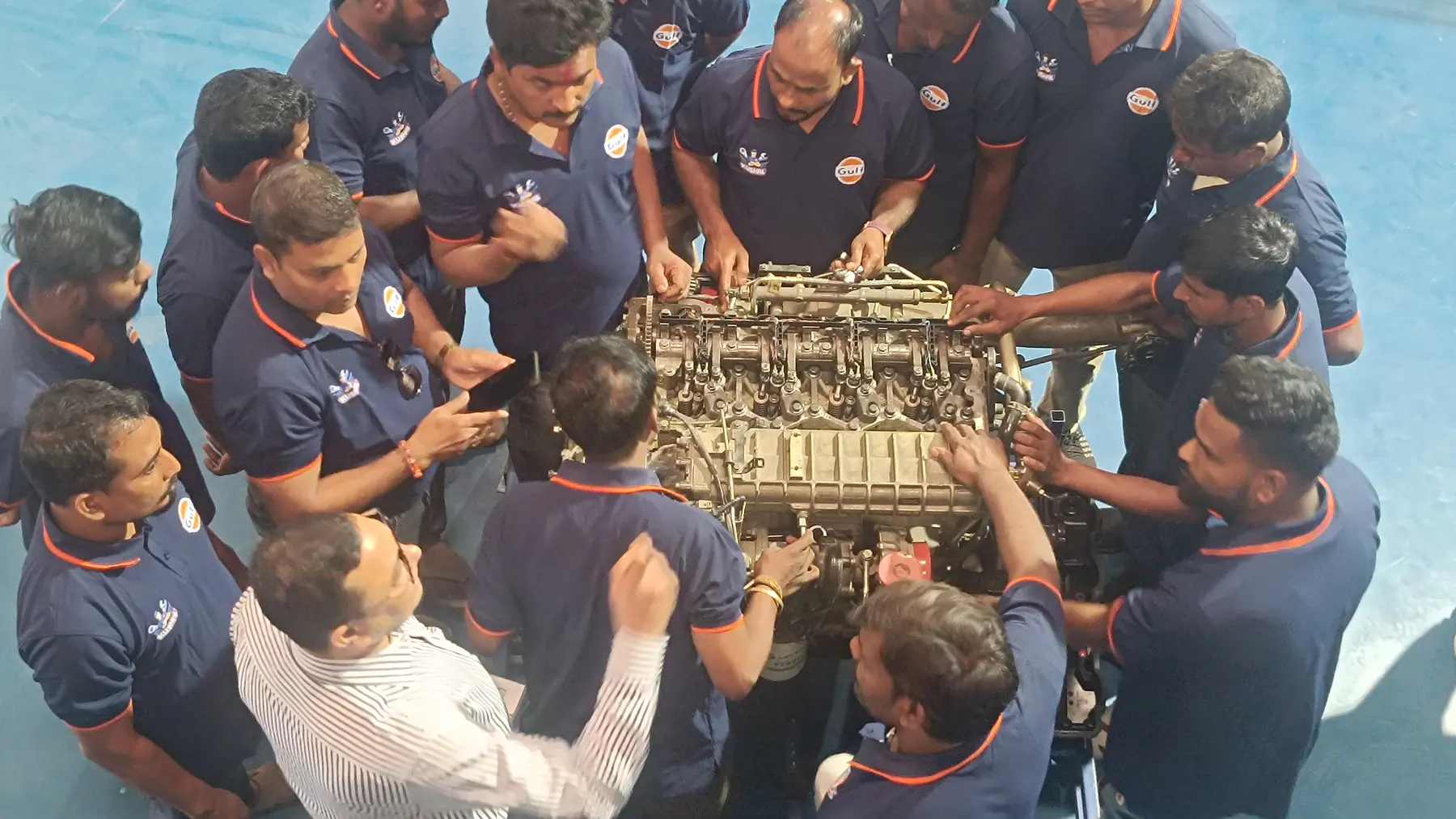 Technicians working through a heavy-vehicle engine teardown