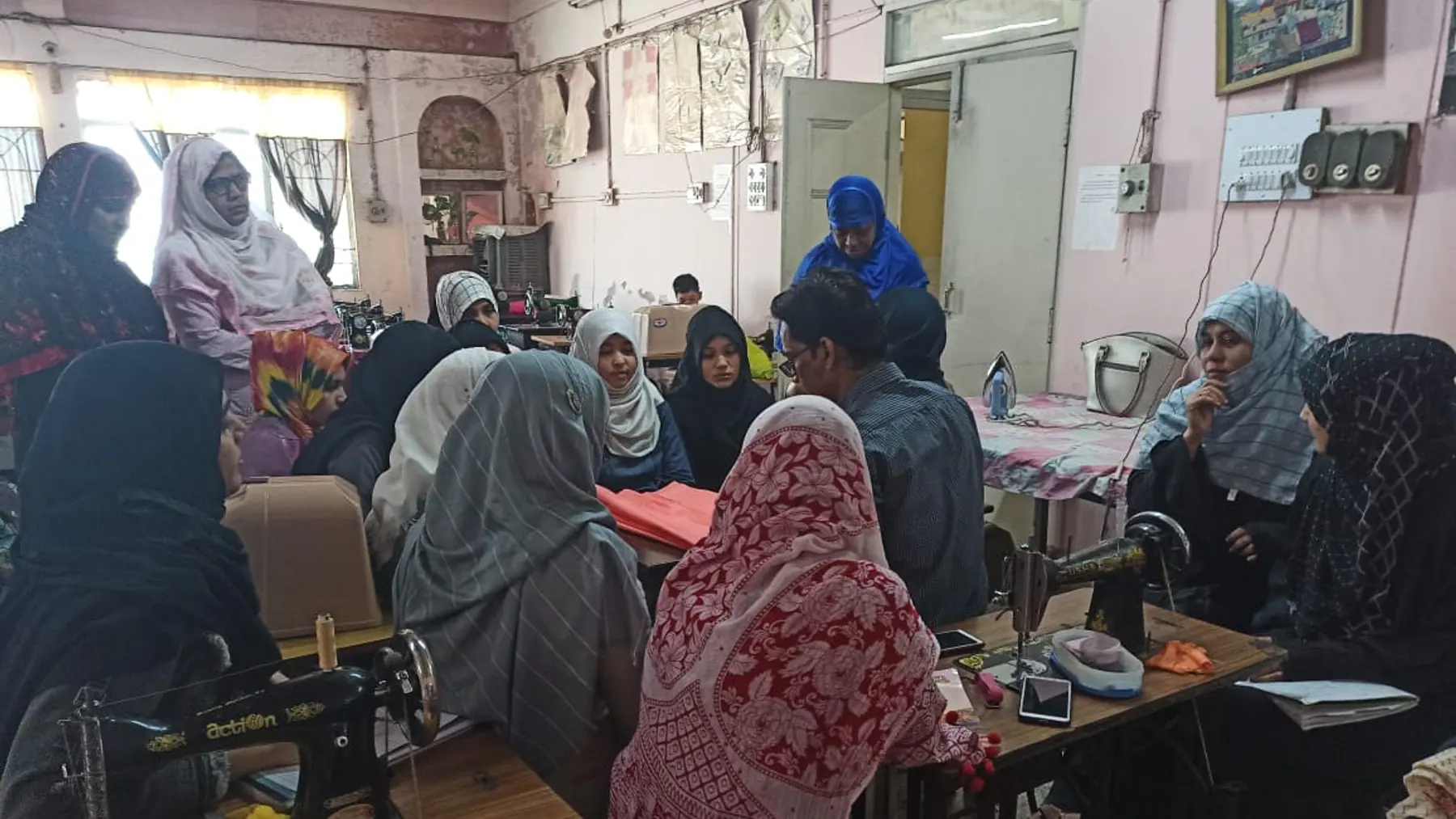 A tailoring floor mid-session, machines in use